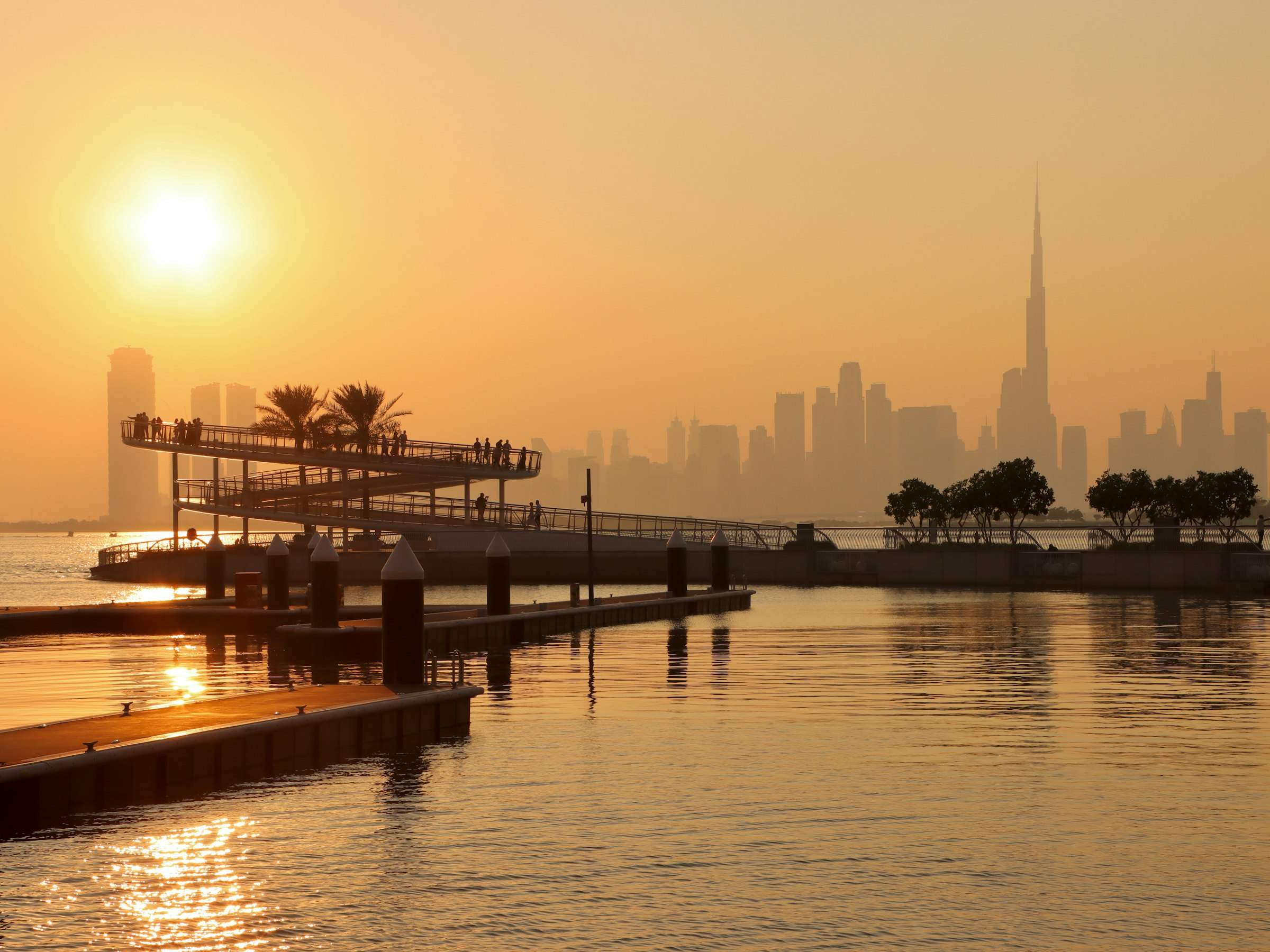 The Dubai skyline across the water at sunset