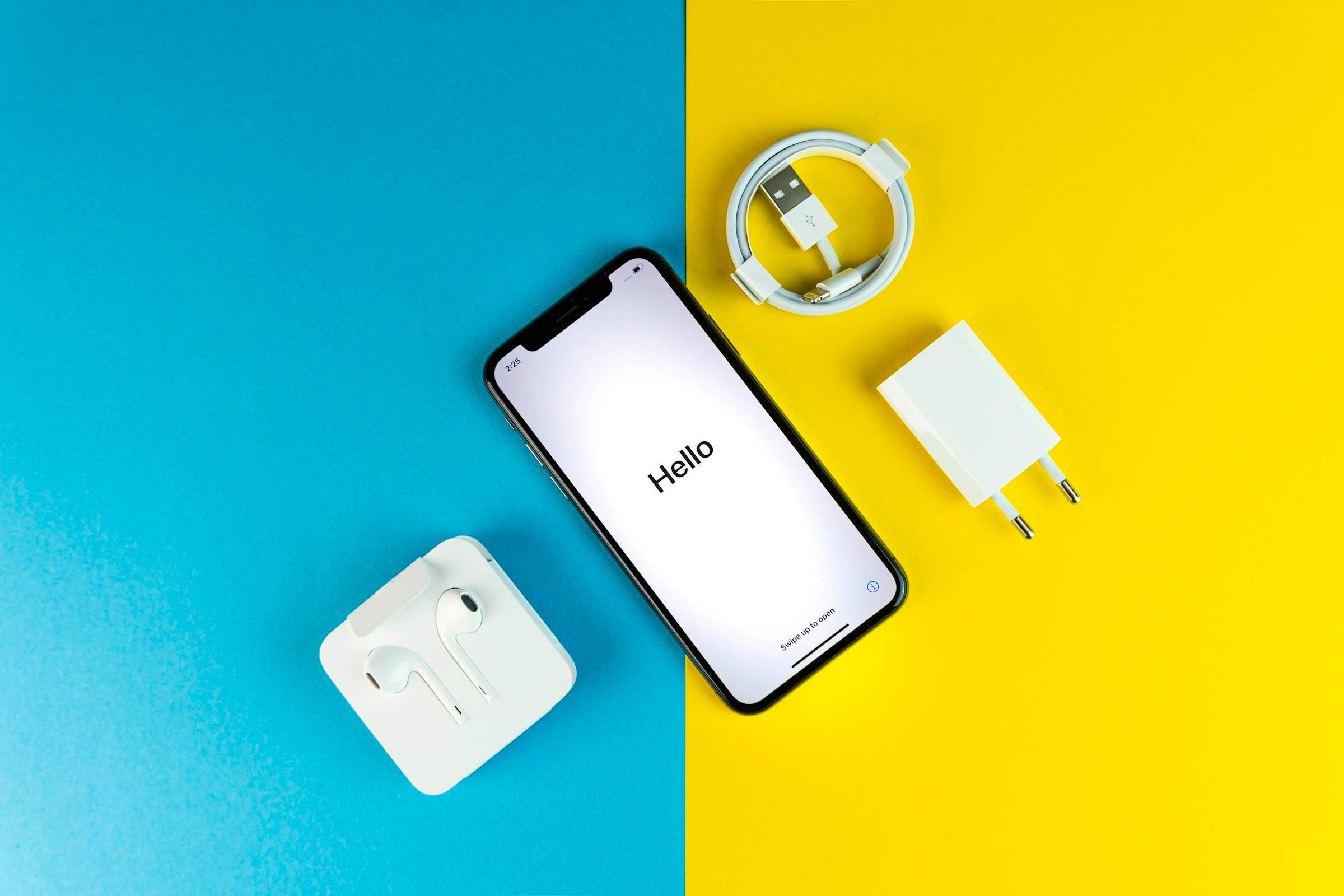 A smartphone with its charger, cable and earphones