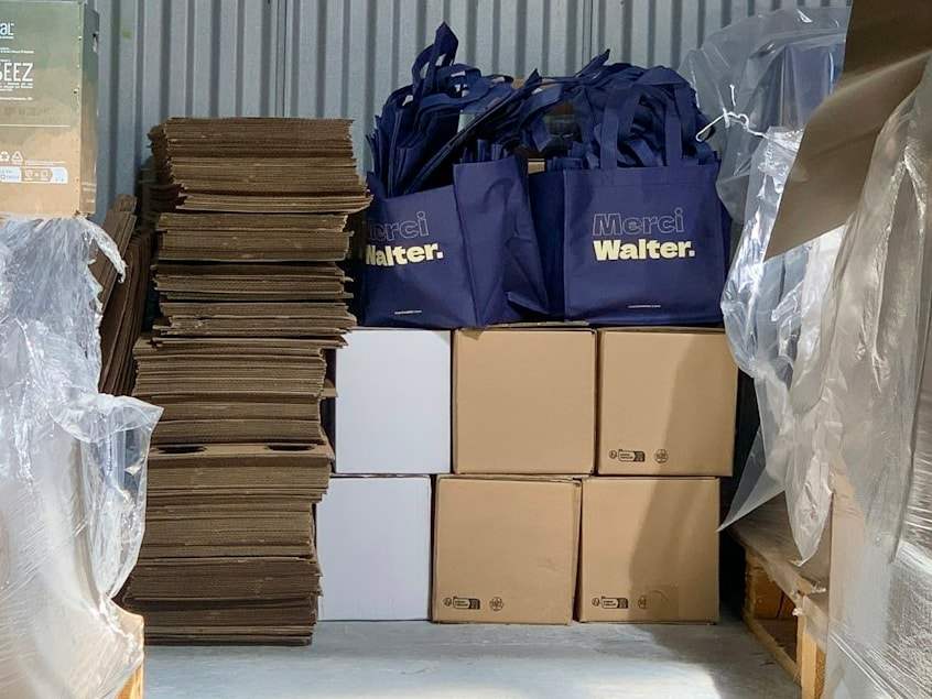 Packed cartons, flattened boxes and shopping bags in a warehouse